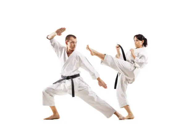 karate girl and boy fighting against white background