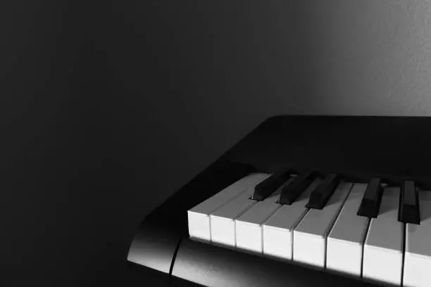 Close-up of Piano with Shadows in the Background