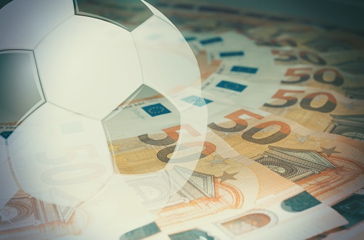 Soccer ball inside euro money , concept of gambling or sports betting.