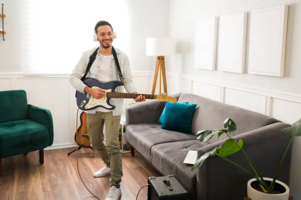 Cheerful guitarist rehearsing