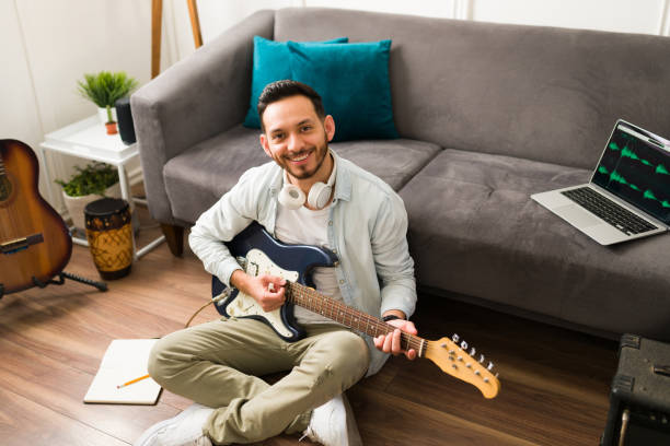 istock Portrait of a smiling guitarist 1372878725