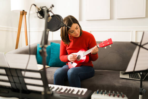 istock Artistic musician learning to play the ukulele 1372879309