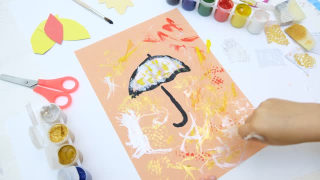 Autumnal card . Child paint umbrella and abstract autumn park use sponge and birds feather like a paintbrush