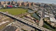 istock Residential district with a distant view on the amusement Luna Park on Coney Island, Brooklyn, on a sunny day.  Aerial footage with the panning camera motion. 1372890103