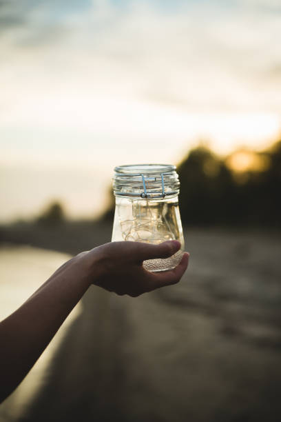 istock Jar with lights on the beach in summer sunset. Sunset colors. Selective focus. 1372894364