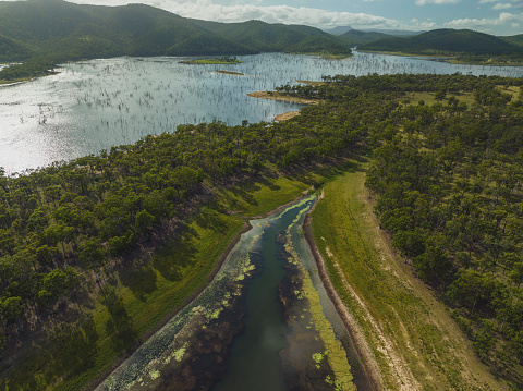 High drone aerial landscape of Eungella Dam, Queensland, Australia. Dead tees are visible due to low water levels.