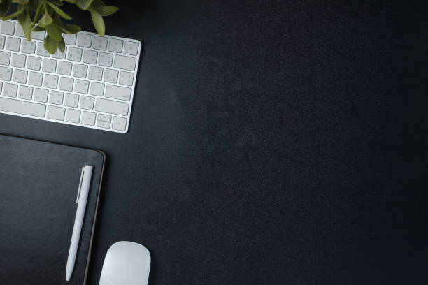 istock top view working desk with keyboard mouse and notebook on black table background 1372896491