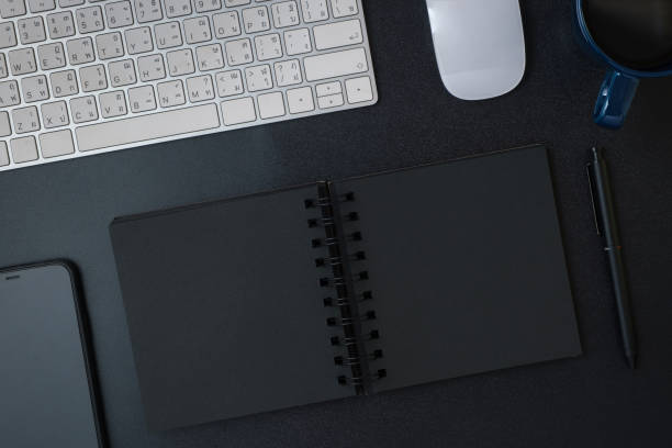 istock top view working desk with keyboard headphone and open notebook on black table background 1372896523