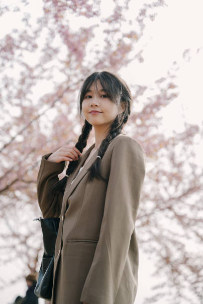 istock Beautiful asian girls under cherry trees 1372898855