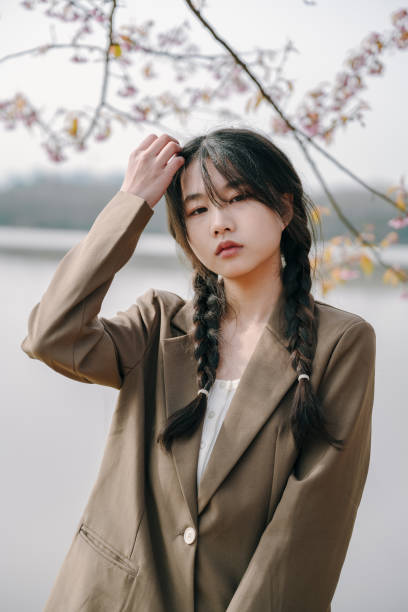 istock Beautiful asian girls under cherry trees 1372898900
