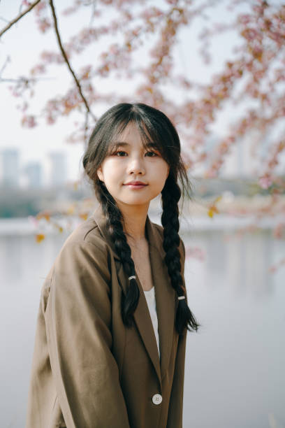 istock Beautiful asian girls under cherry trees 1372898901