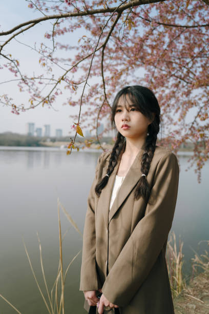 istock Beautiful asian girls under cherry trees 1372899422