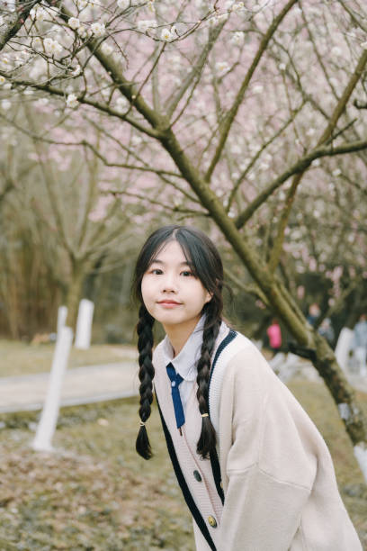 istock Beautiful asian girls under cherry trees 1372899711