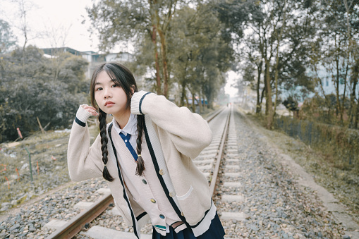 Asian girls resting and playing on the tracks