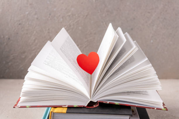 istock a red paper heart floats above an open book, selective focus 1372899901