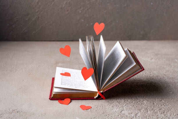 istock red paper hearts fly around an open book 1372899916