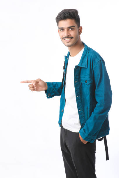 istock Young indian man wear jacket and giving expression over white background. 1372902175
