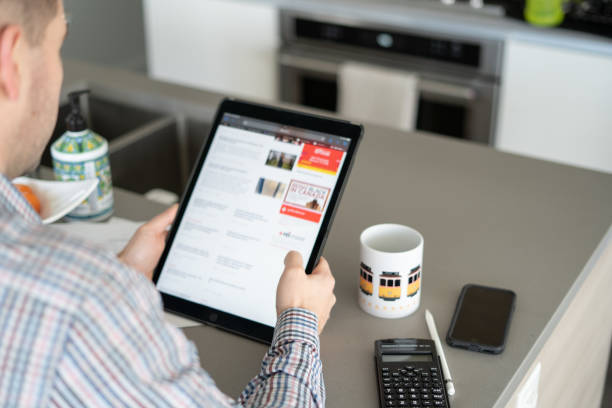 istock Anonymous man checks the news on his tablet 1372902246