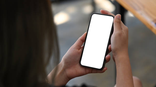 istock Woman hands holding smart phone with white empty screen for advertise. 1372904823