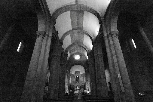 Colegiata Santa María a Real do Sar, XII century church, indoors. Santiago de Compostela old town. Galicia, Spain. Low angle black and white view.