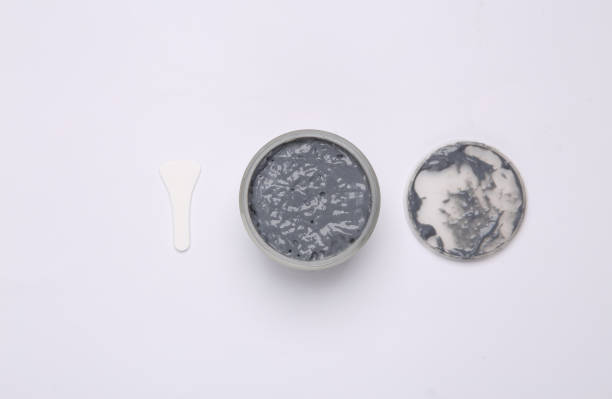 istock Jar of black clay for face on gray background 1372906991