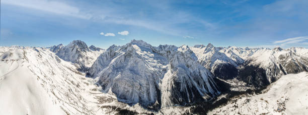istock some clouds over the mountains in the snow 1372911230