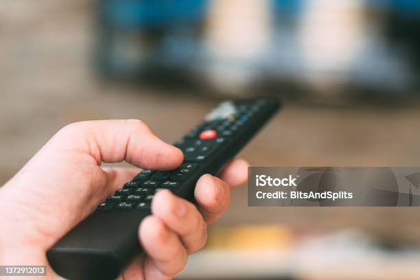 Male Hand Holding Television Remote Controller Stock Photo - Download Image Now - Video On Demand, Television Set, Replay