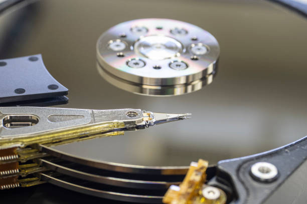 istock computer's hard disk hdd data storage drive without shield cover,  show magnetic disc and electronic circuit inside 1372915350