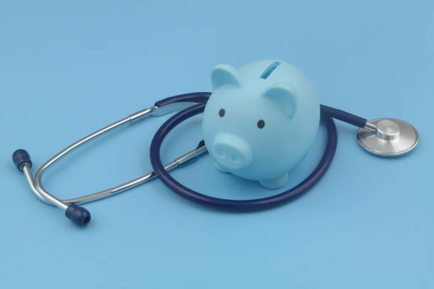 istock Blue piggy bank and stethoscope blue background. 1372918578