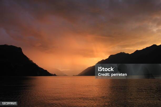 Moody Sky Over Lake Brienz Switzerland Stock Photo - Download Image Now - Dusk, Interlaken - Switzerland, Blue