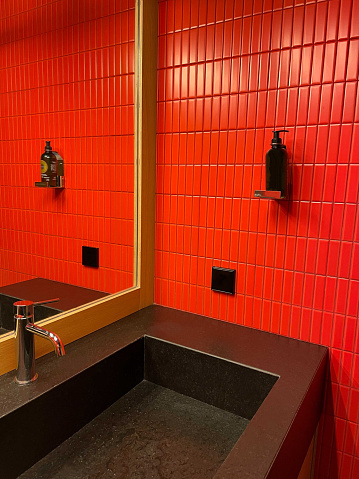 Red tiled public bathroom interior