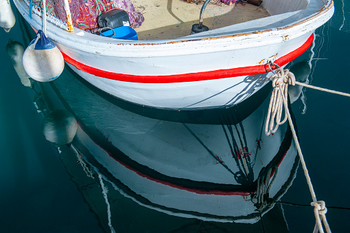 A close-up of wheel of nautical vessel. Sailboat at sea background. Sea transport. Journey concept.