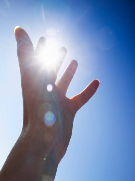 istock Female hands in the blue sky in the backlight 1372924567