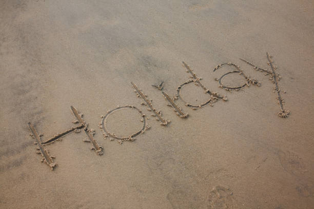 Holiday handwriting on the beach for travel concept