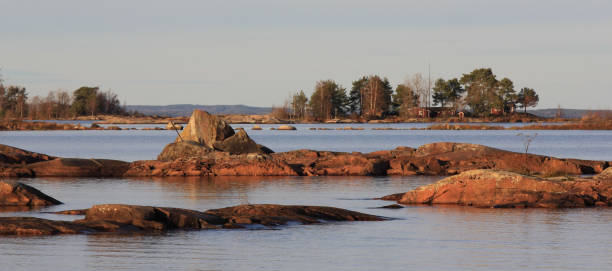 Rock formations and small island at the shore of Lake Vanern, Sweden. stock photo