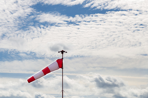 Windsock with cloudy sky in the background