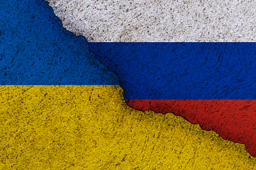 Ukraine and Russia national flags on a grunge texture