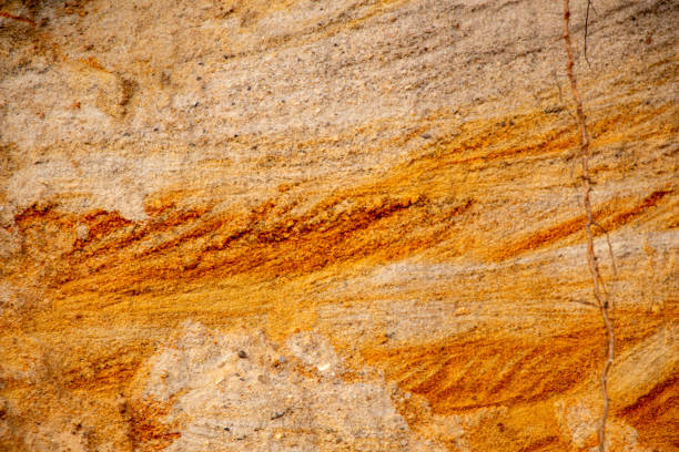 istock Textural sand, with  relief surface, multi-colored layers and different in size of granules, in outdoor sand career, after mining ore and sand for construction. 1372929124