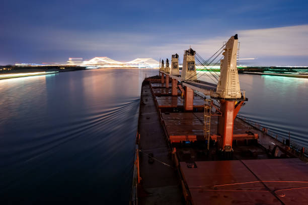 Nautical Vessel (Bulk Carrier Ship) sailing at Detroit Canal at Night Nautical Vessel (Bulk Carrier Ship) sailing at Detroit Canal at Night bulk carrier stock pictures, royalty-free photos & images