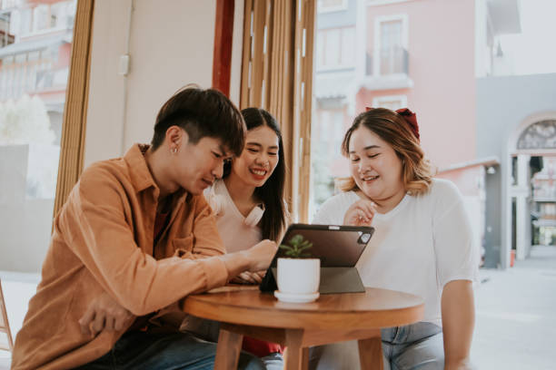 Group of university student brain storming about their thesis project. University students meet at coffee shop to discuss and brainstorming about their thesis project together on weekend. dissertation photos stock pictures, royalty-free photos & images