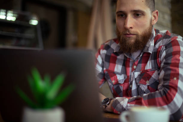 istock A young man doing a project on a laptop while sitting in a coffee shop. 1372933963