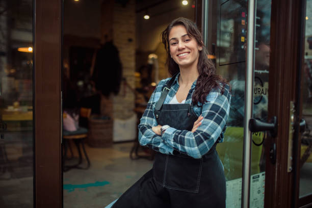 istock Front view of a young waitress with an apron. 1372933979