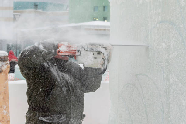 istock The sculptor cuts a figure from an ice block with a gasoline saw 1372935708