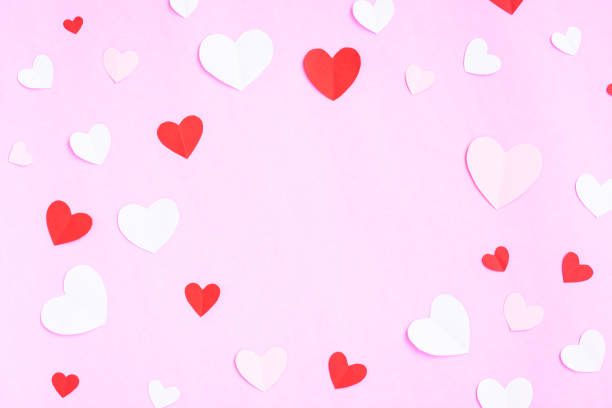 istock Hearts papercut on pink background 1372940485
