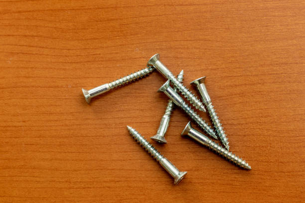 istock Metal screws on a wooden board 1372942800