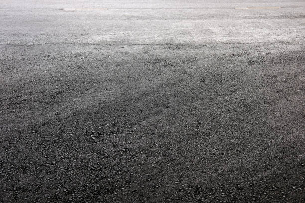 istock asphalt surface on a big city road 1372944746