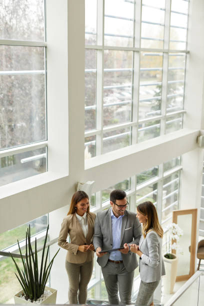 istock Young business people discussing ideas over digital tablet on staircase 1372944845
