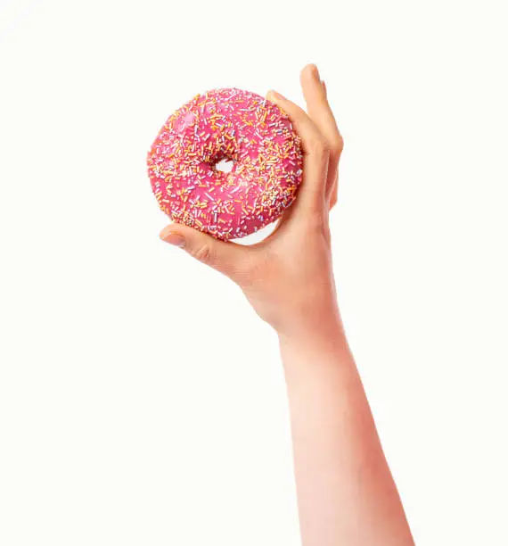 Photo of hand showing a pink donut