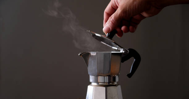 istock Coffee beans in Moka pot and smoke. 1372946983