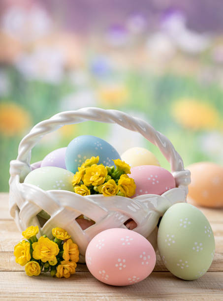 istock Easter eggs and flowers in a basket and on a wooden table 1372950630